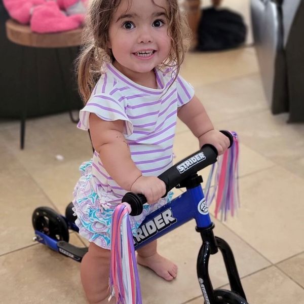 Jordyn tests out her Adaptive Strider Bike