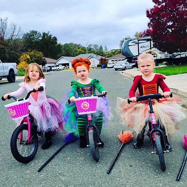 Three witches on Strider bikes