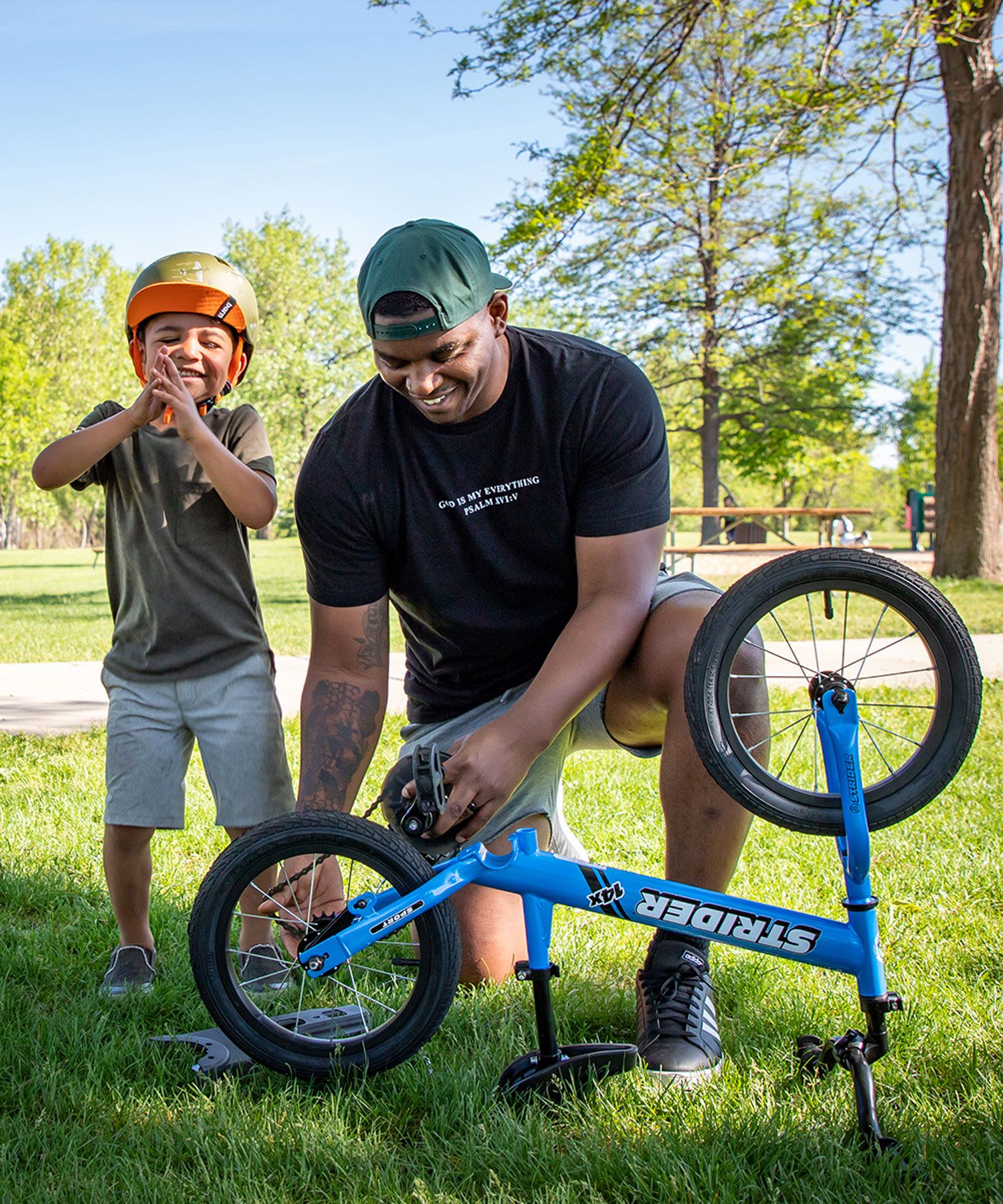 Boy eagerly waits for his dad to put the pedals on his Strider 14x Sport bike